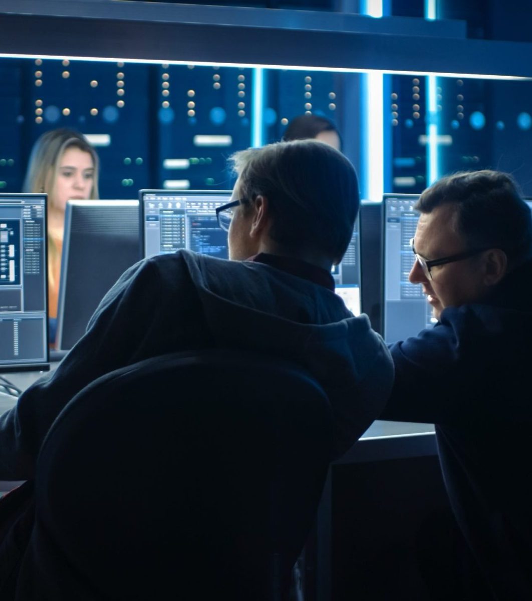 Team of IT Programers Working on Desktop Computers in Data Cente