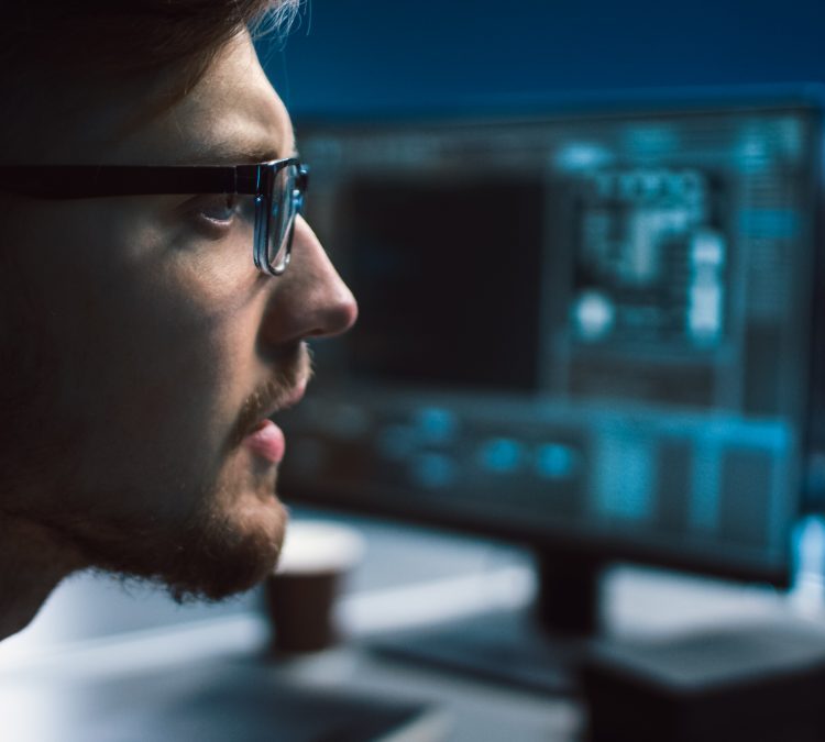 Portrait of IT Specialist Wearing Glasses Works on Personal Comp