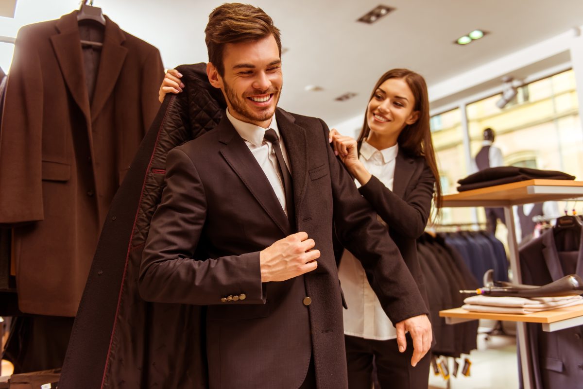 People in suit shop trying on jackets