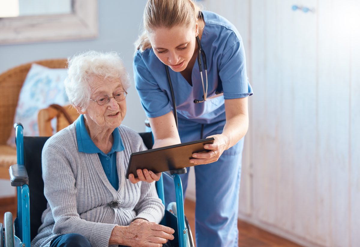 Nursing home, woman or doctor with tablet checking medical results, chart online or social media. Healthcare, tech and nurse caregiver help consulting with elderly patient in living room or bedroom.